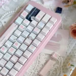 A close-up view of the whimsical Wish Sticky Note PBT Dye-Sub Keycaps Set, showcasing playful pastel hues and handwritten doodle designs from a new angle.