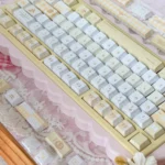 Detailed view of the elegant Yellow Rose Garden PBT Cherry Keycap Set, showcasing vibrant yellow rose artistry and subtle green accents from a unique angles.