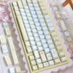Elegant PBT Yellow Rose Cherry Keycap Set from various angles, revealing vibrant yellow roses and green accents on a clean, artistic base.