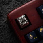 Detailed shot of the Pure Brass Yu-Gi-Oh! Cross Artisan Keycap from a unique angle, highlighting its intricate sculpted design and gleaming metallic finish.