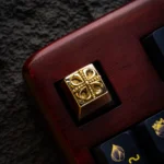 Gleaming pure brass Yu-Gi-Oh! Cross artisan keycap, showcasing its intricate design and premium metallic yellow finish.