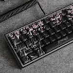 "Iconic Zero Two PBT Dye-sub keycap set for DARLING in the FRANXX, featuring vibrant anime art and delicate Sakura motifs from various angles."