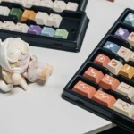 AIer PBT Keycaps Set, close-up view revealing vibrant AI and designer iconography. Premium PBT material with playful pixel art details for creative setup.