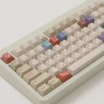 AIer PBT Keycaps Set with playful AI & designer pixel art, showcasing vibrant colors and premium PBT texture from a detailed angle.