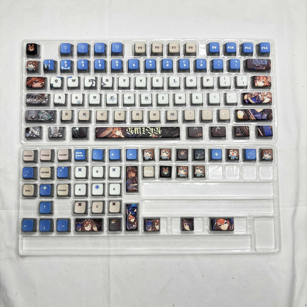 Angled view of Arknights Amiya RGB PBT keycaps set, revealing the character's artistic design and cosmic motifs, perfectly enhancing RGB keyboard.