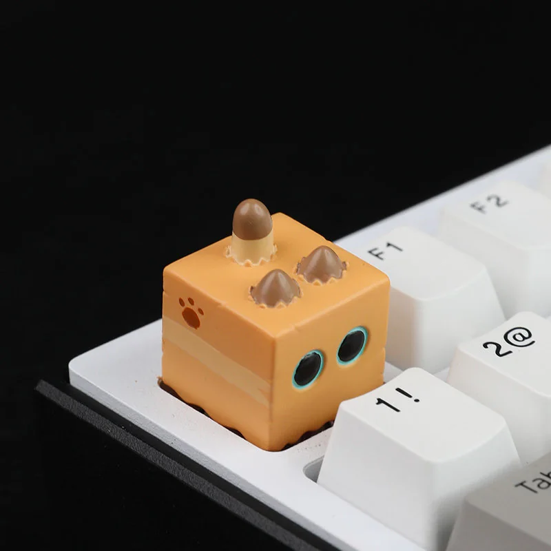 Whimsical handcrafted cat in box artisan resin keycap. Intricate miniature cat within charming resin casing. Artistic keyboard detail.