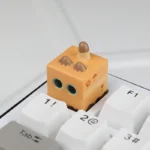 Close-up of a whimsical handcrafted resin artisan cat in box keycap, showcasing its intricate miniature sculpting and charm from a unique design.