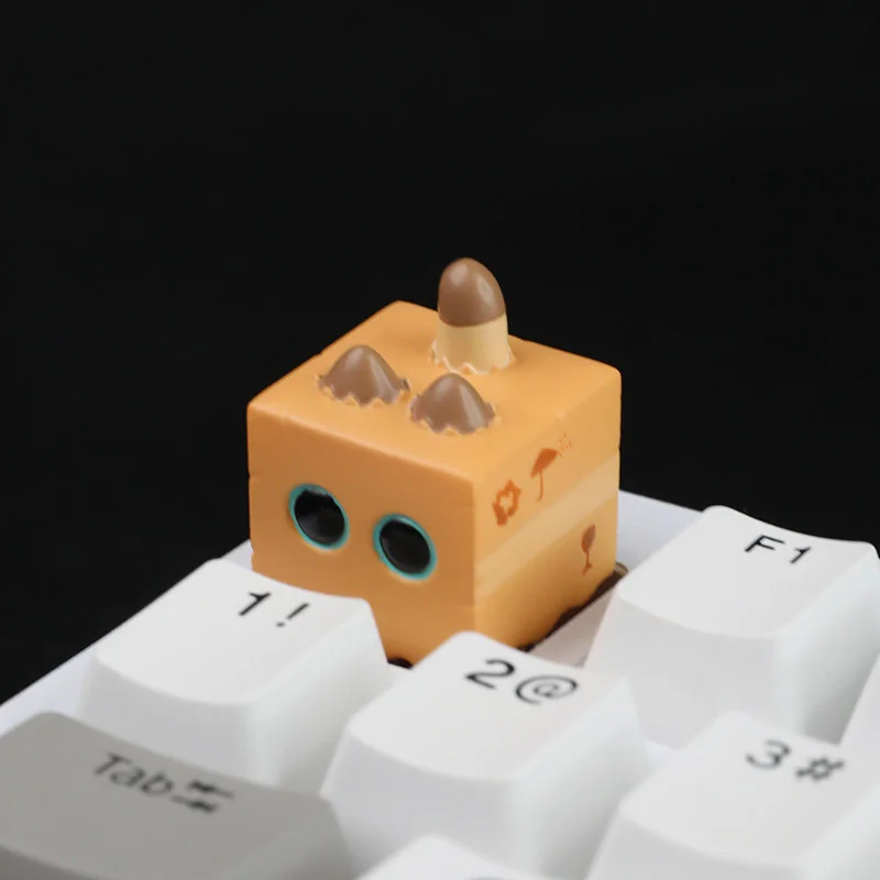 Artistic handcrafted artisan cat keycap, featuring a whimsical miniature cat intricately sculpted inside resin box.