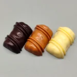 Artisan chocolate resin keycap, handcrafted with smooth, warm chocolate colors, from various angles for keyboard customization.