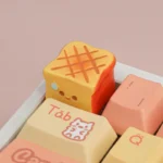 Detailed close-up of a whimsical handcrafted miniature roasted food artisan keycap, showcasing its intricate textures and warm, inviting culinary aesthetics.
