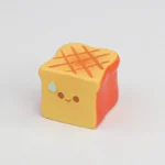 Whimsical handcrafted artisan keycap featuring a miniature golden-brown roasted food, perfect for mechanical keyboards, capturing a warm culinary aesthetics.