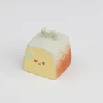 A charming miniature roasted fish artisan keycap, handcrafted with whimsical detail, featuring golden-brown tones and a playful culinary theme.