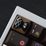 Close-up of a whimsical handcrafted resin fish bone artisan keycap, showcasing its unique charm and vibrant aquatic details from multiple angles.