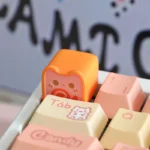 Close-up of a whimsical handcrafted Meow Toast Snack artisan keycap, showcasing its adorable miniature design from multiple delightful angles.