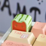 Handcrafted Whimsical Meow Toast Snack Artisan Keycap from a unique angle, revealing its adorable food-themed miniature design and playful details.