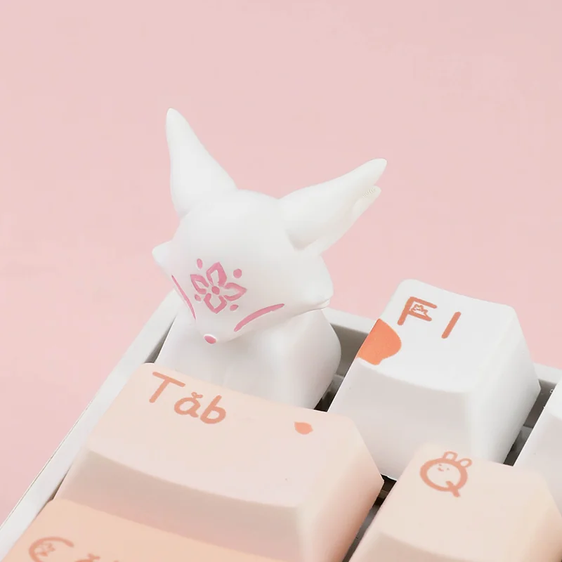Frontal view of the unique handcrafted ESC artisan keycap, revealing a mythical fox gracefully nestled amidst delicate blossoms design.