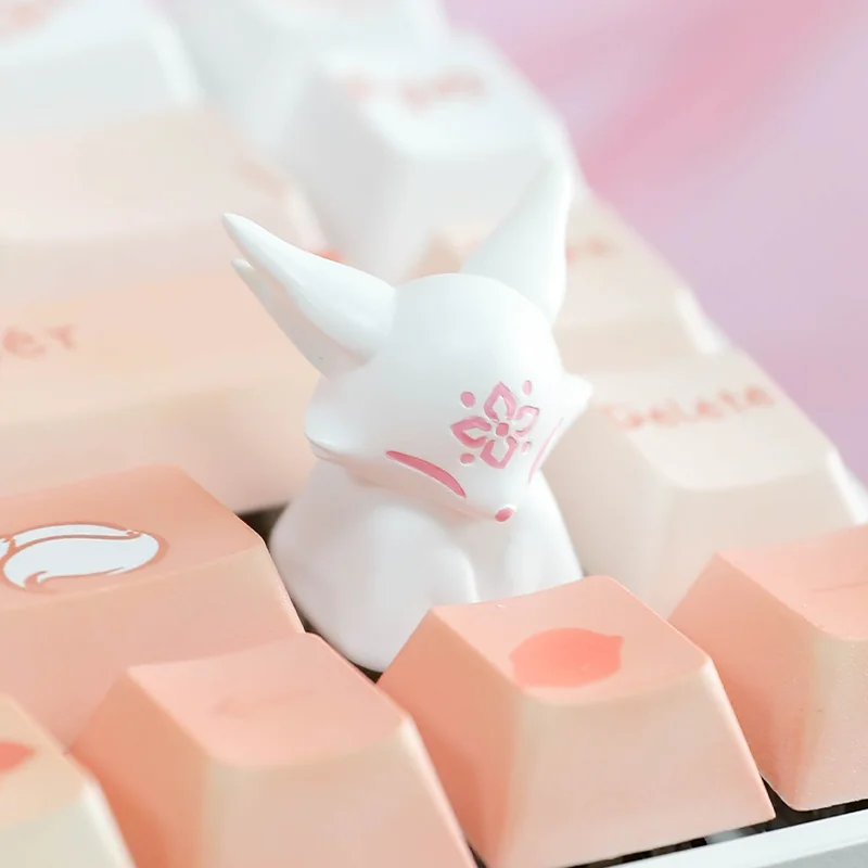 Unique handcrafted artisan resin keycap, showing a mythical fox among delicate peach blossoms. Translucent resin reveals intricate details, evoking artistic design.