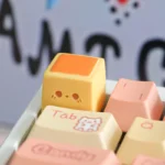 Close-up views of a handcrafted whimsical pineapple biscuit artisan keycap, showcasing its vibrant colors and intricate miniature dessert details from various angle.