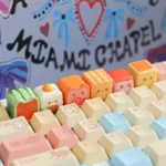 Close-up of a whimsical handcrafted strawberry pudding artisan keycap for ESC, showcasing its adorable miniature dessert design and vibrant details angle.