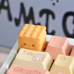 Close-up of a whimsical snack artisan Biscuit keycap for ESC, showcasing its adorable handcrafted details and dessert-inspired design from multiple angles.