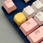 A Shell Chocolate handcrafted artisan resin keycap featuring a creamy yellow shell pattern, evoking a gourmet chocolate caramel dessert.