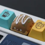 A charming artisan resin keycap featuring a detailed Wangzai Cat and Takoyaki, captured from multiple angles to highlight its playful, unique miniature design.
