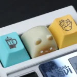 Charming Wangzai Cat & Takoyaki artisan resin keycap showcased from a delightful angle, revealing intricate details and vibrant, playful miniature scene.