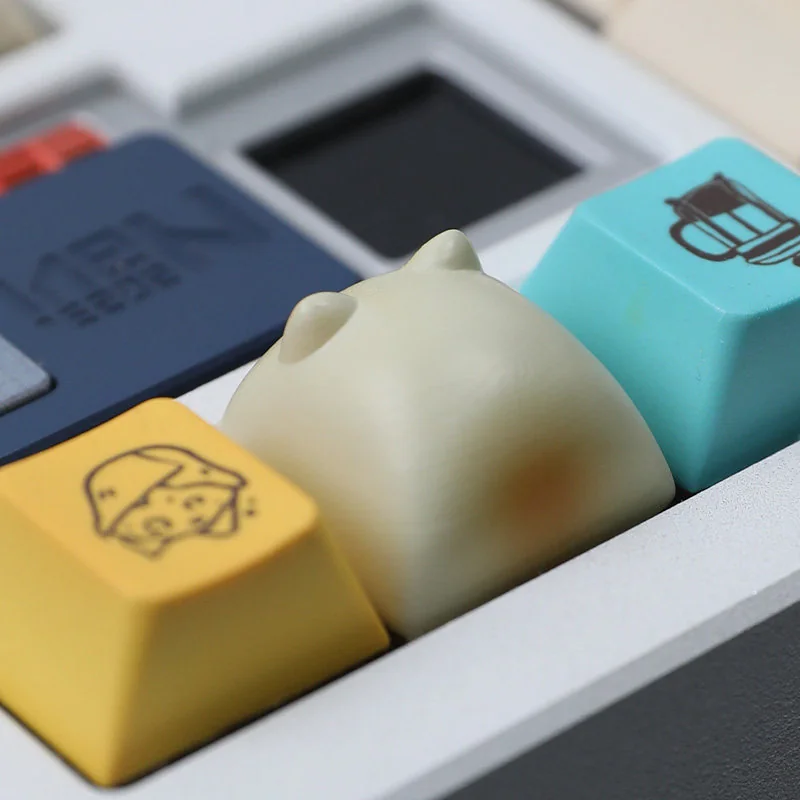 Detailed artisan resin keycaps featuring the charming Wangzai Cat and playful Takoyaki, presented from multiple angles to highlight unique craftsmanship.