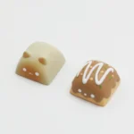 Charming artisan resin keycap featuring a playful Wangzai Cat with detailed miniature takoyaki, showcasing unique craftsmanship and vibrant design.
