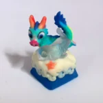 Handcrafted 3D translucent resin Azure Dragon artisan keycap, viewed from a unique angle, highlighting its intricate sculpture and mystical glow.
