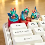 Close-up of a handcrafted 3D translucent resin Azure Dragon artisan keycap, showcasing its intricate scales and glowing mystical fantasy aesthetic.
