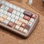 A whimsical Bear Bakery PBT keycap set displayed from various angles, featuring adorable bears, pastries, and warm pastel colors in a cozy bakery design.