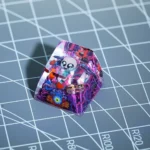 Exclusive Binding of Isaac SA R1 keycap showcasing vibrant Isaac character art from multiple angles, highlighting its unique artisanal quality.