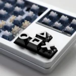 Close-up of Black Piano Gaming Console Button Keycaps for gaming consoles, showcasing their sleek finish and durable industrial design from multiple angles.