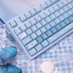 Ethereal Misty Blue Butterfly PBT Dye-Sub Keycaps set displayed from multiple angles, showcasing delicate pastel hues and dreamy butterfly designs.