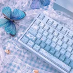Ethereal Misty Blue Butterfly PBT Dye-Sub Keycaps Set, viewed from multiple angles, revealing delicate blue butterfly designs and soft pastel hues for artistic keyboard.