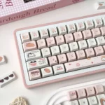 Detailed view of playful Bread Bear Cherry keycaps set from multiple angles, highlighting their unique character design, warm colors, and charming bread illustration.