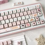 Whimsical Bread Bear Cherry profile keycaps set, showcasing multiple angles of the unique, cozy bear and bread character designs in a warm color palette.