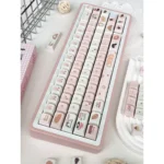 Whimsical Bread Bear Cherry profile keycaps set displayed from various angles, highlighting their unique, cozy bear and bread illustrations and warm color palette.