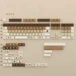 A full 145-key coffee-themed PBT dye-sub keycap set for mechanical keyboards, showcasing warm aesthetics and charming cat accents. Unique angle.