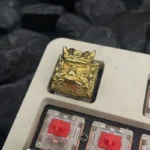 Premium handcrafted bright brass Oni Warrior keycap, showcasing its intricate Japanese warrior design and polished, radiant finish for a fierce aesthetics.