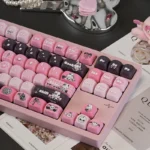 This artistic Sweet Cool Bunny Keycap Set is showcased from a dynamic angle, highlighting its striking black and pink design and unique edgy-cute aesthetics.