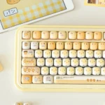 Playful Burnt Toast PBT keycaps set with warm hues and crisp dye-sub legends, shown from various angles, mimicking toasted bread.