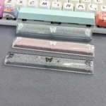 Close-up views of a handcrafted translucent butterfly artisan space key keycap, showcasing its ethereal resin glow and delicate details from various angle.