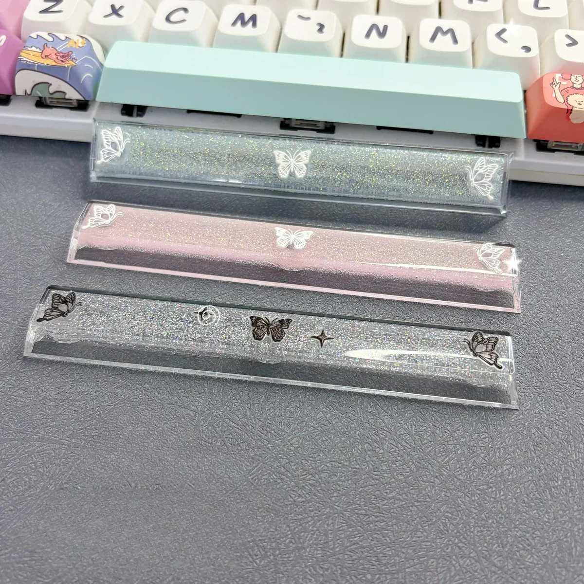 Close-up views of a handcrafted translucent butterfly artisan space key keycap, showcasing its ethereal resin glow and delicate details from various angle.