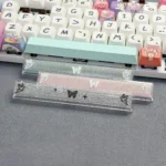Close-up of a handcrafted translucent butterfly artisan space key keycap from different angles, showcasing its ethereal glow and delicate resin detail.