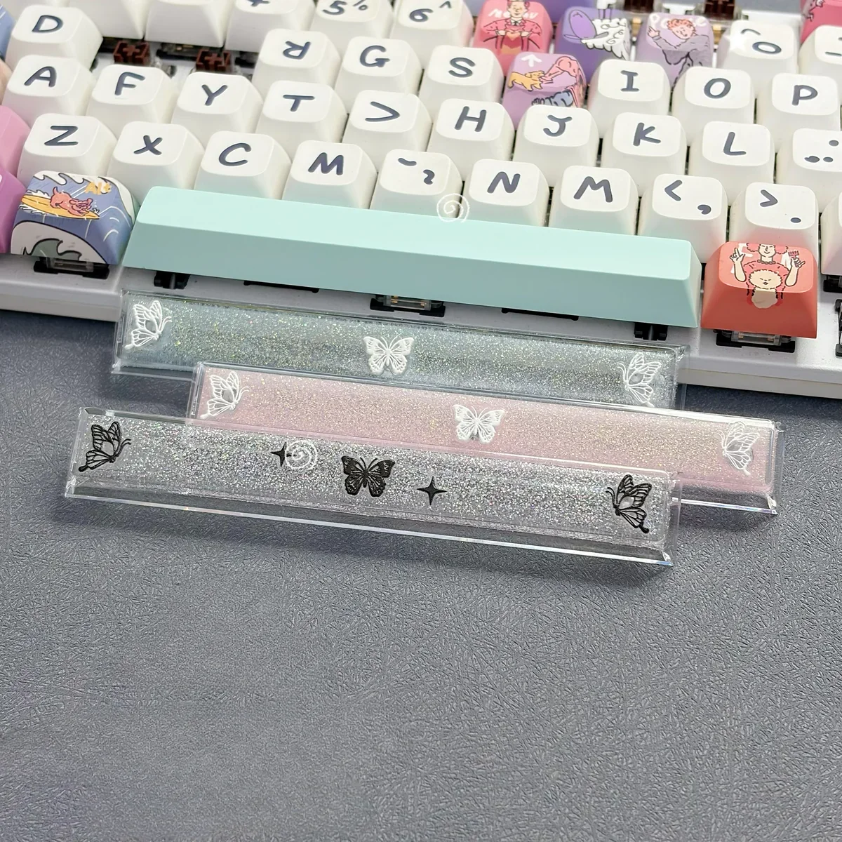 Close-up of a handcrafted translucent butterfly artisan space key keycap from different angles, showcasing its ethereal glow and delicate resin detail.