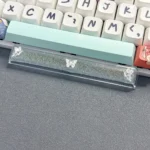 Close-up views of a handcrafted translucent butterfly artisan space key keycap, showcasing its ethereal resin details and delicate glowing aesthetic.