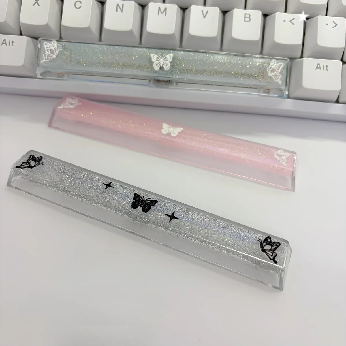 Handcrafted translucent butterfly artisan space key keycap, showcasing delicate ethereal butterflies glowing within resin, a unique artistic keyboard.