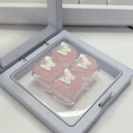 Handcrafted ethereal pink butterfly resin keycap in multiple detailed views, showcasing its translucent design and shimmering glitter for a dreamy keyboard.